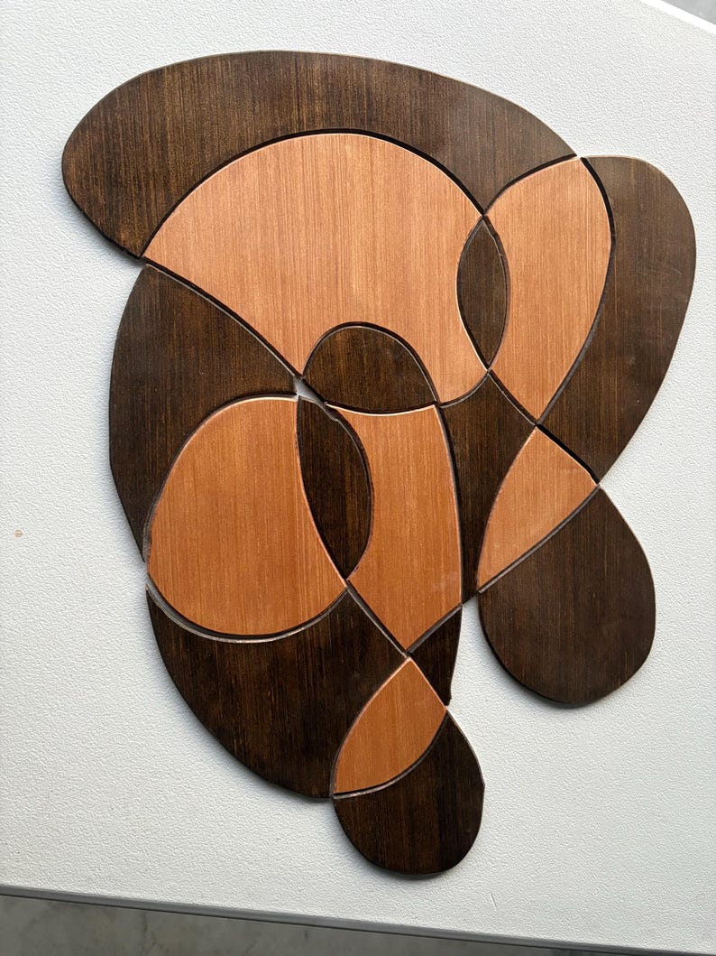 Wall piece in dark walnut and warm copper-toned wood