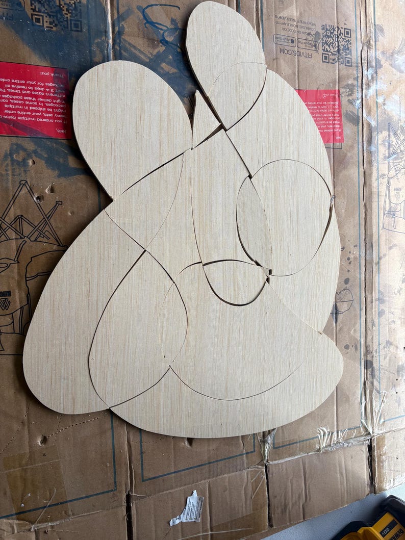 Unfinished wooden pieces fitted together into the full design